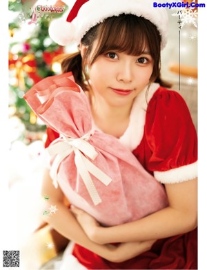 A woman in a red dress and a santa hat.
