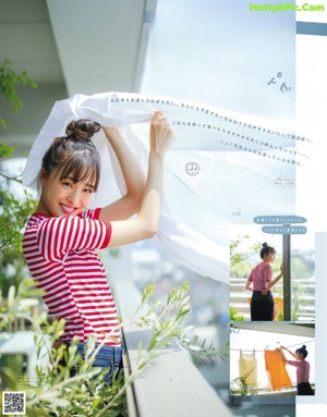 A woman eating a piece of food with a spoon.