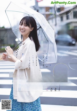 A magazine with a picture of a woman in a striped shirt.
