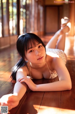 A woman in a pink bra posing for a picture.