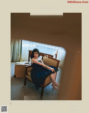 A woman laying on a bed in a hotel room.