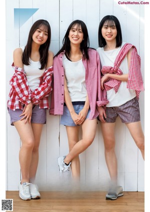A group of young women laying on top of each other.