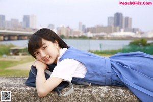 A woman in a blue dress is posing for a picture.