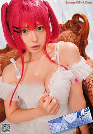 A woman with pink hair is posing for a picture.