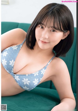 A woman in a red and white bikini holding a book.
