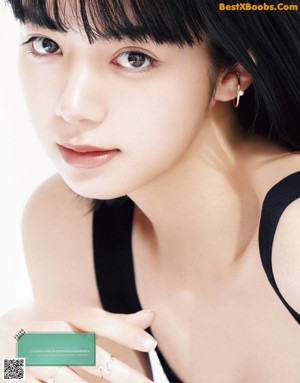 A woman in a black dress posing for a picture.