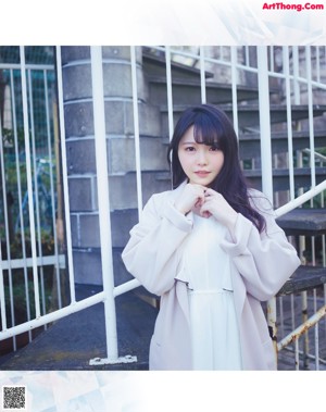 A woman with long black hair is posing for a picture.