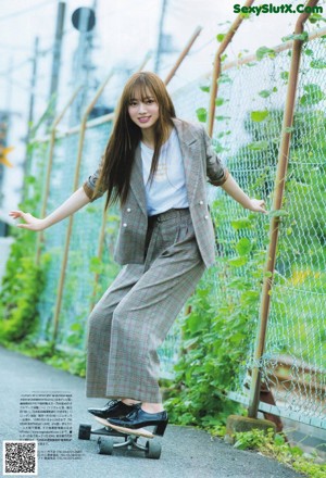 A woman in a plaid suit posing for a picture.